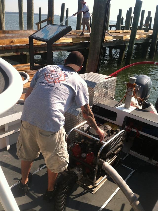 FF Clark and FF Hall operating the pump on Boat5